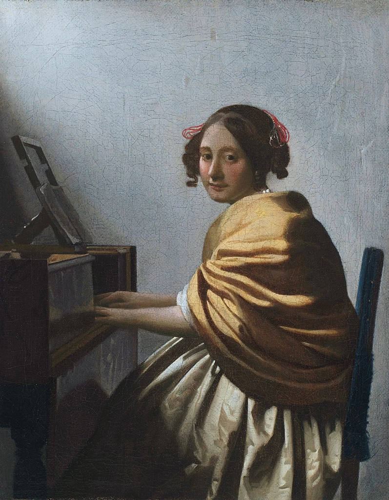 Giovane donna seduta alla spinetta